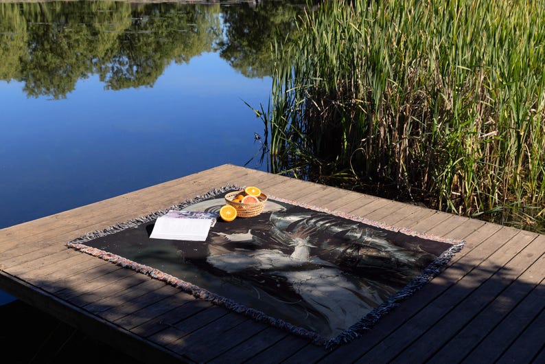 a plate of food on a wooden table next to a body of water