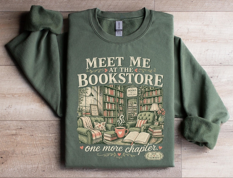 Green sweatshirt with "Meet Me At The Bookstore" and book-themed illustration.