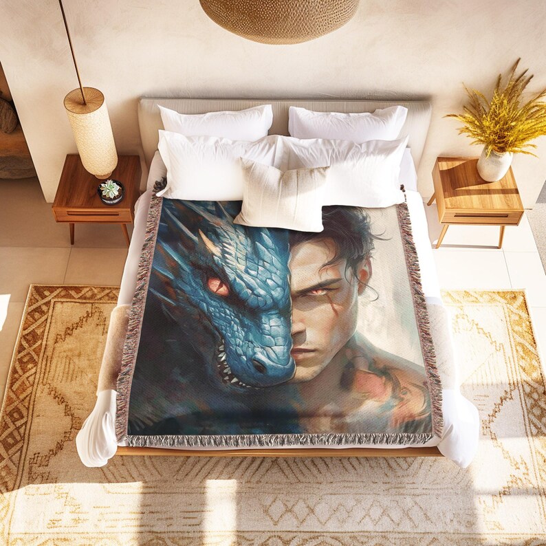 a bed with a blanket on it with a picture of a man and a dragon