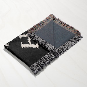 a black and grey scarf with a white and black design