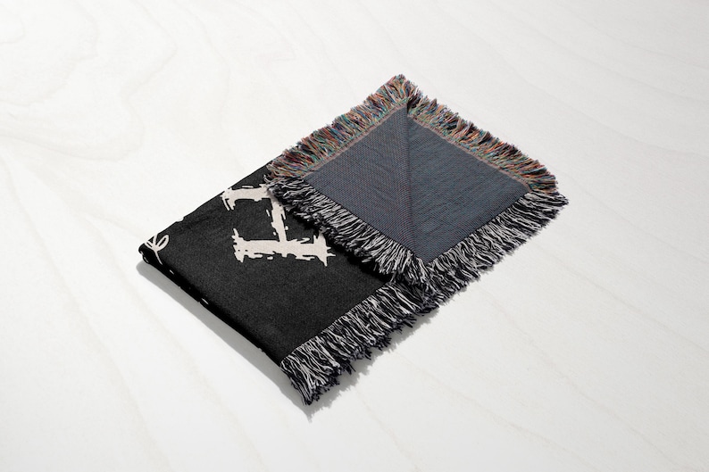 a black and grey scarf with a white and black design
