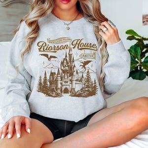 a woman sitting on a bed with her legs crossed