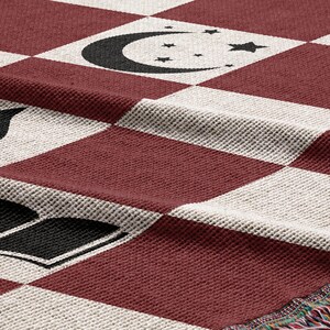 a red and white checkered table cloth with black and white symbols
