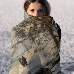 a woman is holding a blanket over her head
