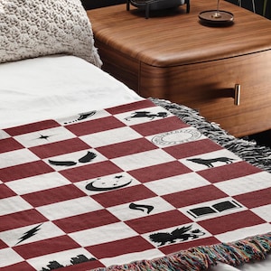 a bed with a red and white checkered blanket