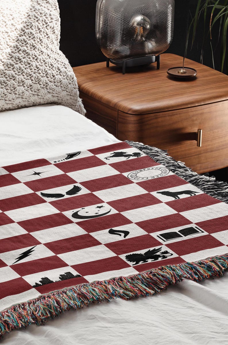 a bed with a red and white checkered blanket