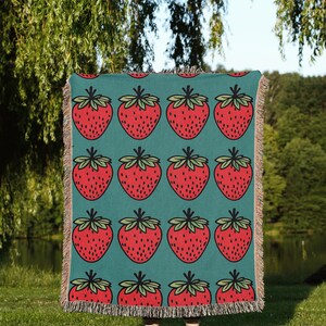 a blanket with strawberries on a blue background