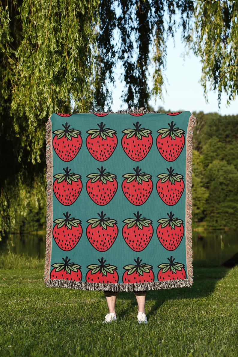 a blanket with strawberries on a blue background