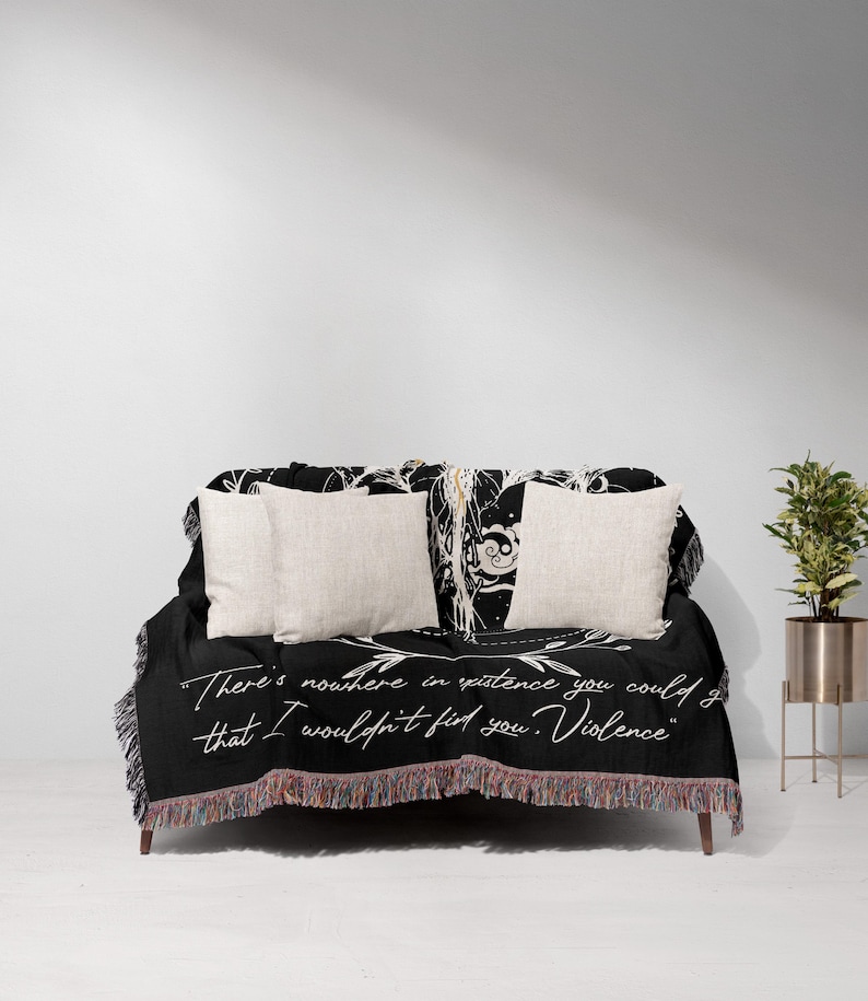 a bed with a black and white comforter and pillows