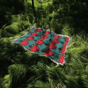 a red and blue umbrella sitting in the grass