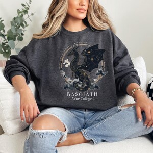 a woman sitting on a couch wearing a black sweatshirt