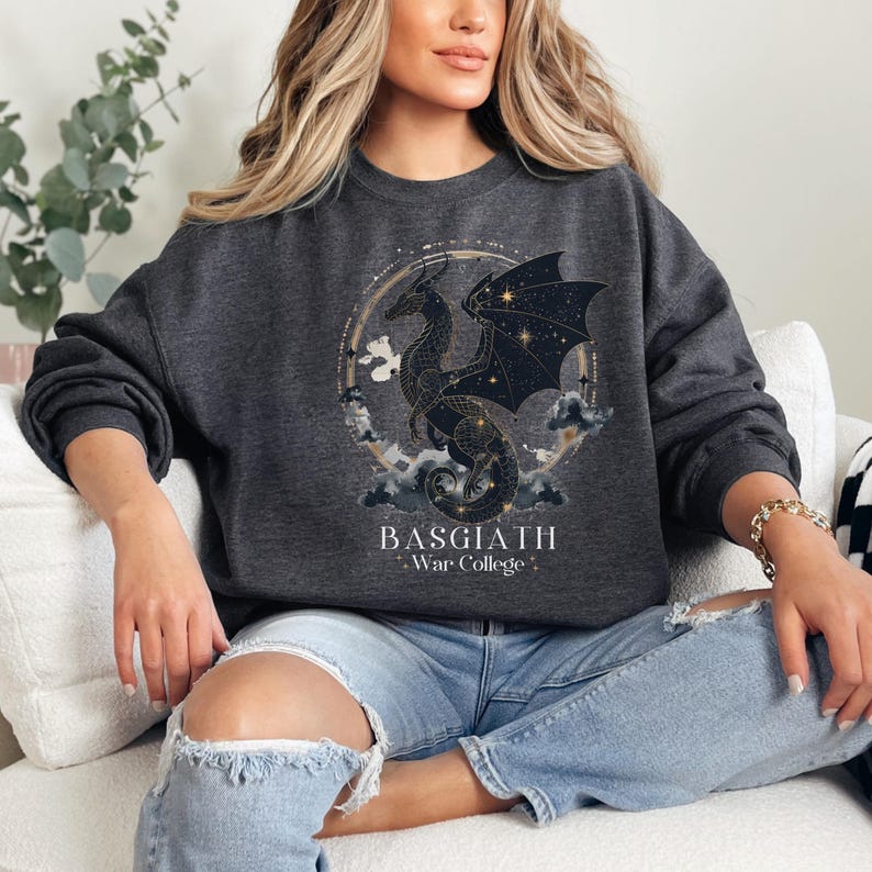 a woman sitting on a couch wearing a black sweatshirt