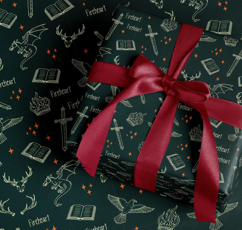 a gift box with a red ribbon tied around it, set against a dark green background with a repeating pattern of white illustrations of a dragon, a book, a sword, and a crown.