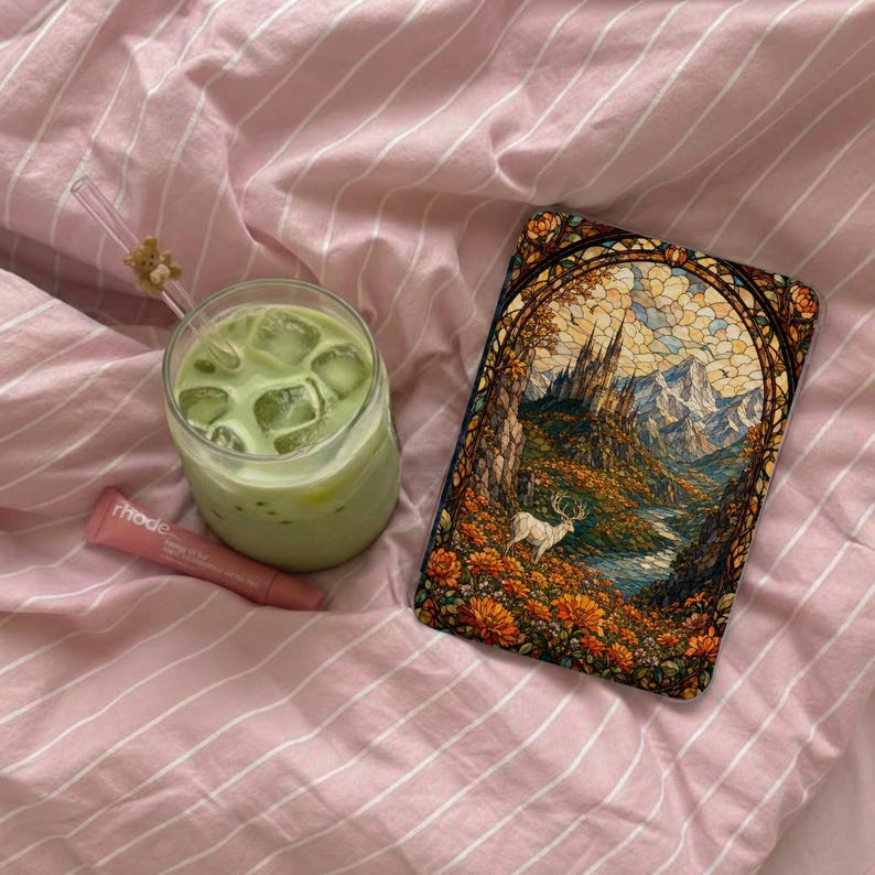 Phone case with stained glass art of castle, mountains, deer, and flowers.