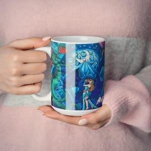 a woman holding a coffee mug with a picture of a mermaid on it
