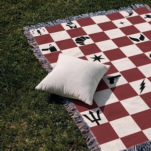 a red and white checkered blanket with a pillow on it