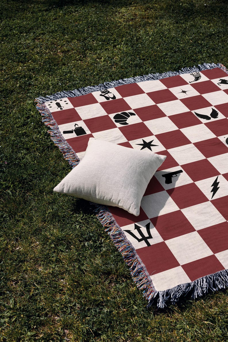a red and white checkered blanket with a pillow on it