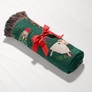 a green towel with a red bow and a picture of a pig on it