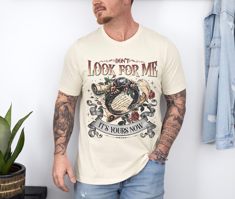 a man with a tattooed arm standing in front of a wall
