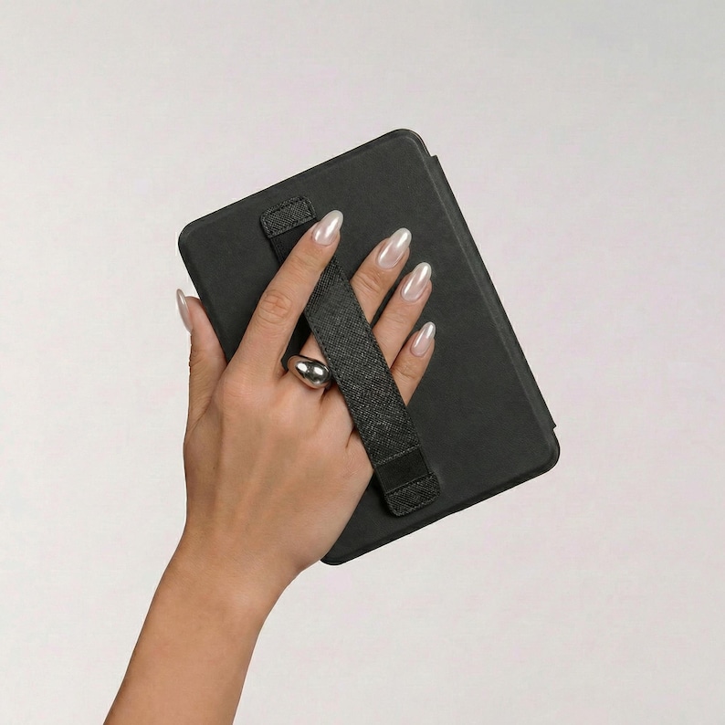 Pearlescent Almond Nails, Chunky Silver Dome Ring, Stylish Hand Holding Device, Elegant E-Reader Case Grip, Modern Tablet Cover Aesthetic