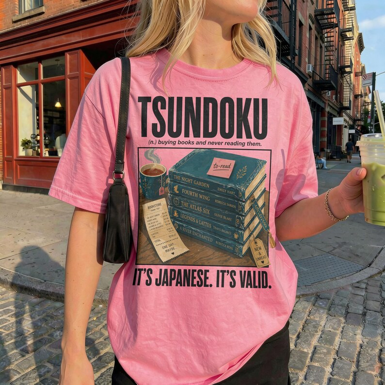 Pink t-shirt with "Tsundoku" and a stack of books labeled "to-read".