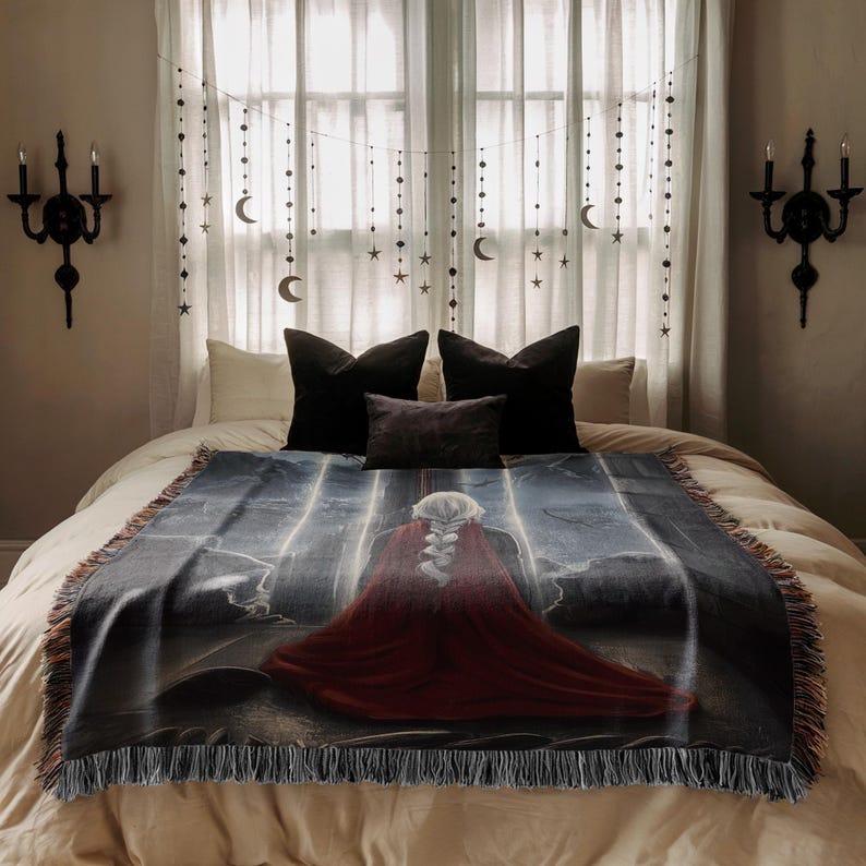 a bedroom with a large bed, a red blanket with a painting of a woman, and a window with curtains and star decorations.