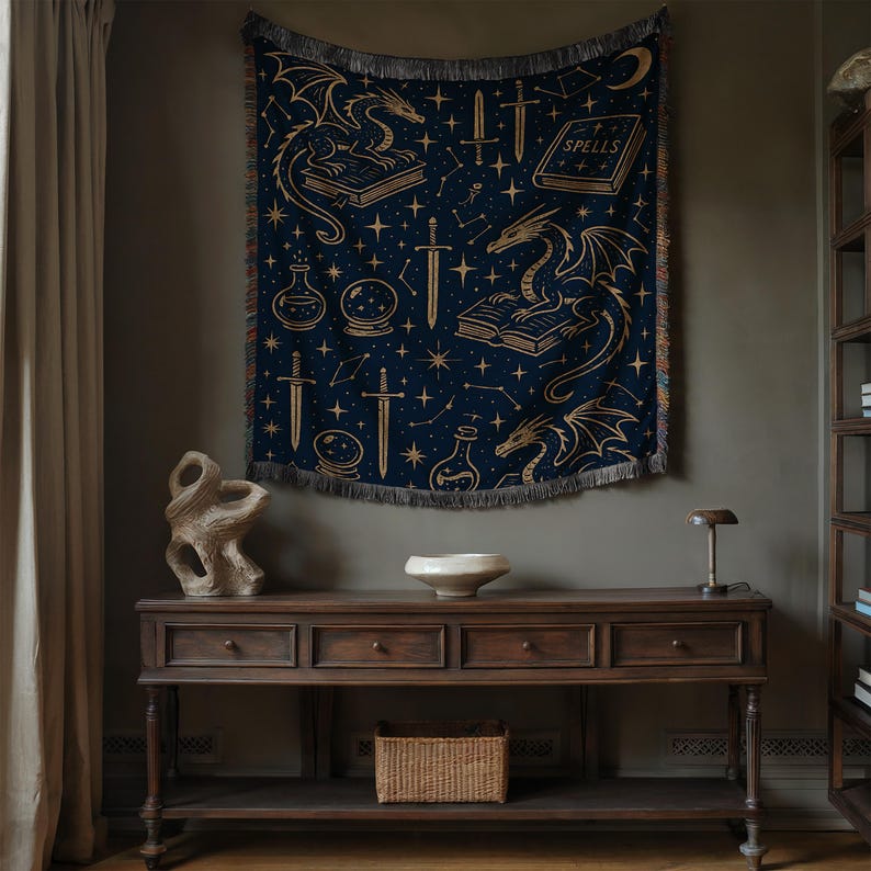 a dark wooden table with a white bowl on top, and a dragon tapestry hanging above it. The tapestry has a starry night sky design and includes various objects such as a book, a vase, and a lamp.
