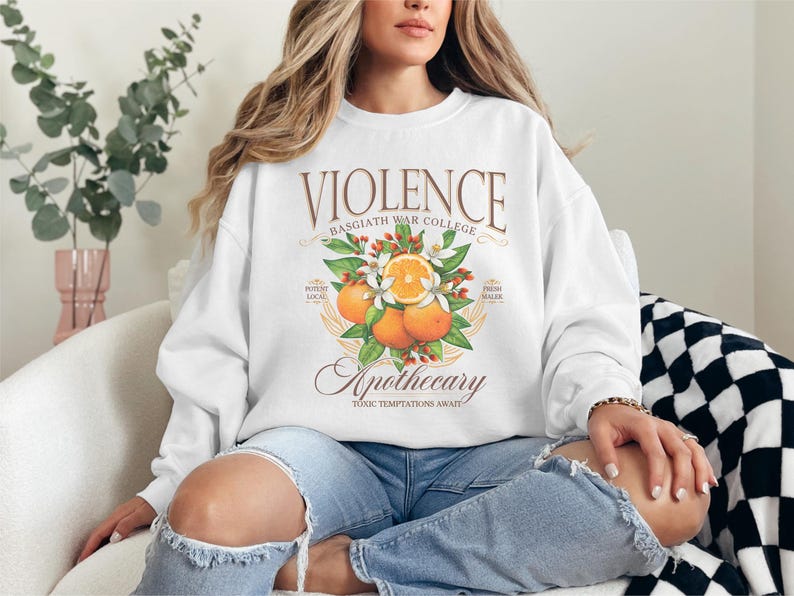 a woman sitting on a couch wearing a white sweatshirt