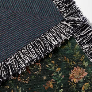 a close up of a blanket with a flower pattern