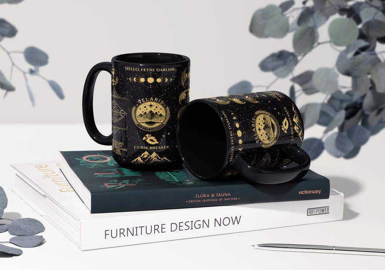 two coffee mugs sitting on top of a book