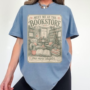 T-shirt with "Meet Me at the Bookstore" text and cozy reading scene.