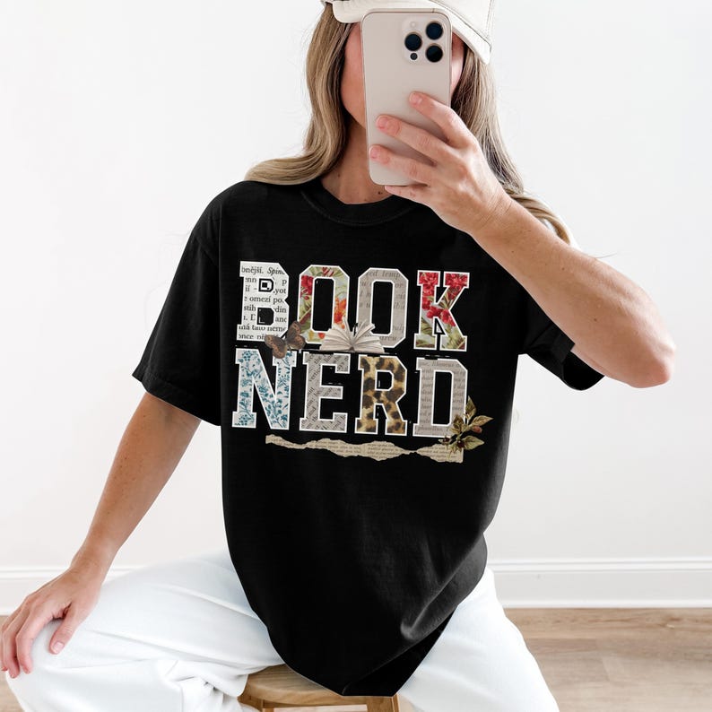 Black t-shirt with "BOOK NERD" text and floral accents.
