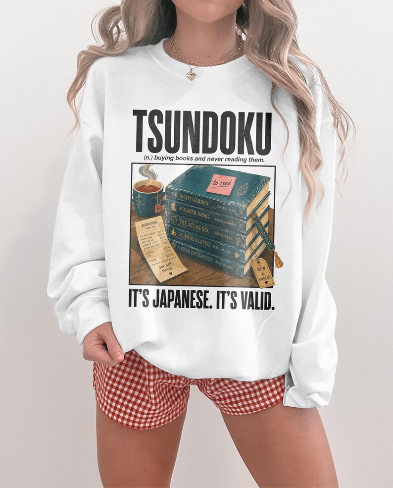 Sweatshirt with "TSUNDOKU" text, books, and receipt.