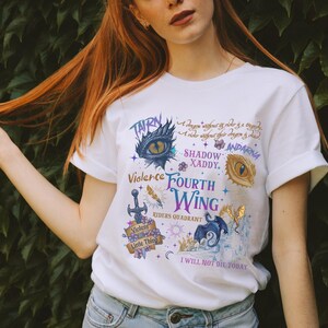a woman with long red hair wearing a white t - shirt