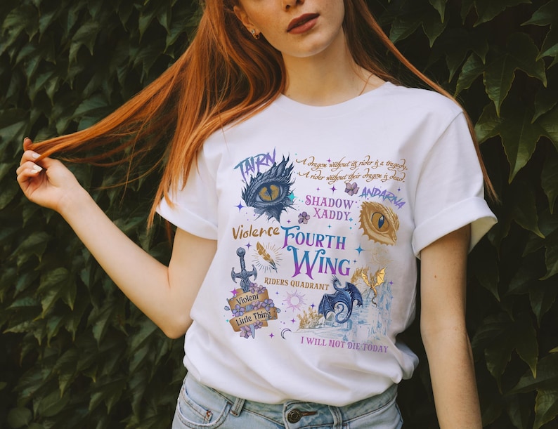 a woman with long red hair wearing a white t - shirt