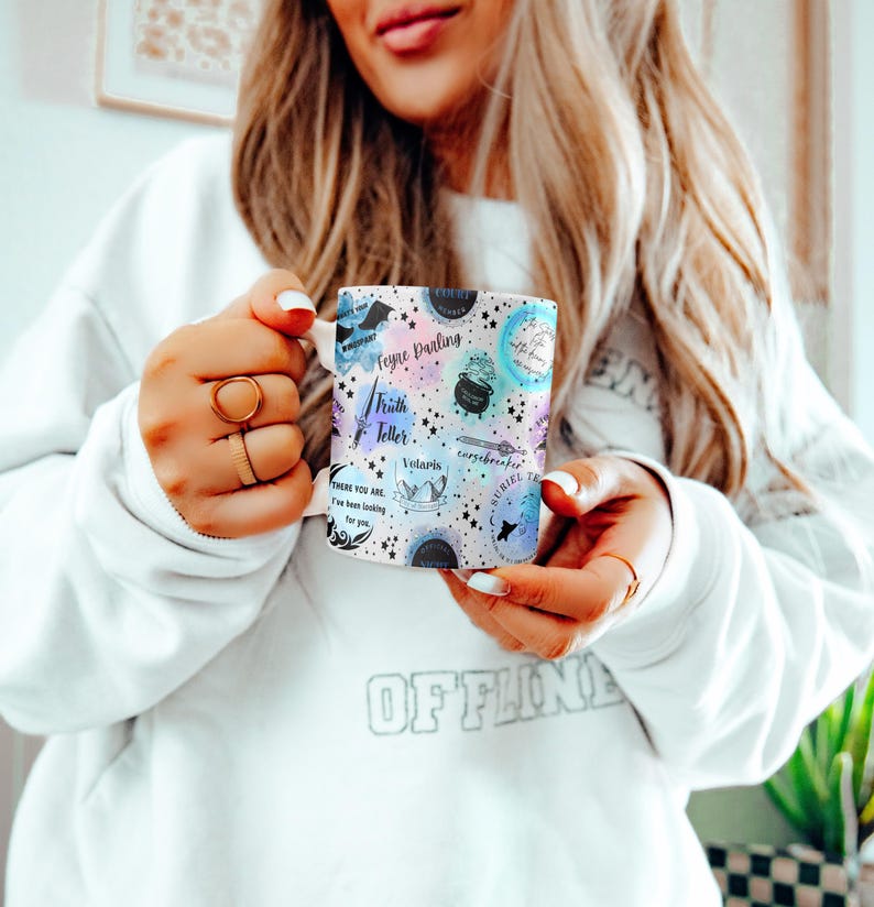 a woman in a white sweatshirt holding a cell phone