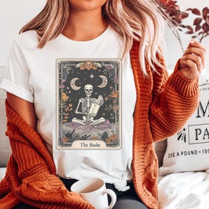 The Reader&quot; Tarot Card Shirt, Halloween shirt, Gothic Reading Skeleton, Ideal for Writers & Book Lovers, Trendy Halloween Tee