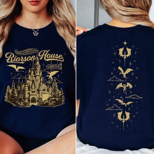 a woman sitting on a bed wearing a harry potter shirt
