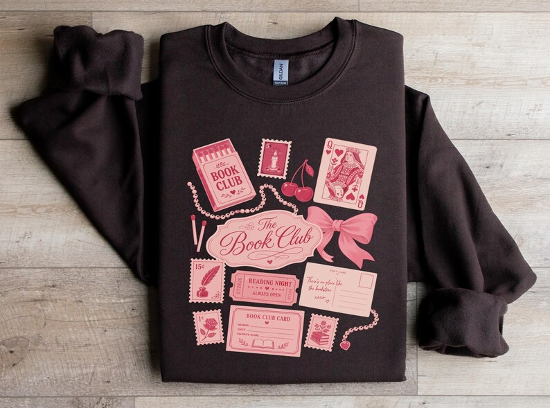 Dark sweatshirt with "The Book Club" design featuring playing cards and mail.