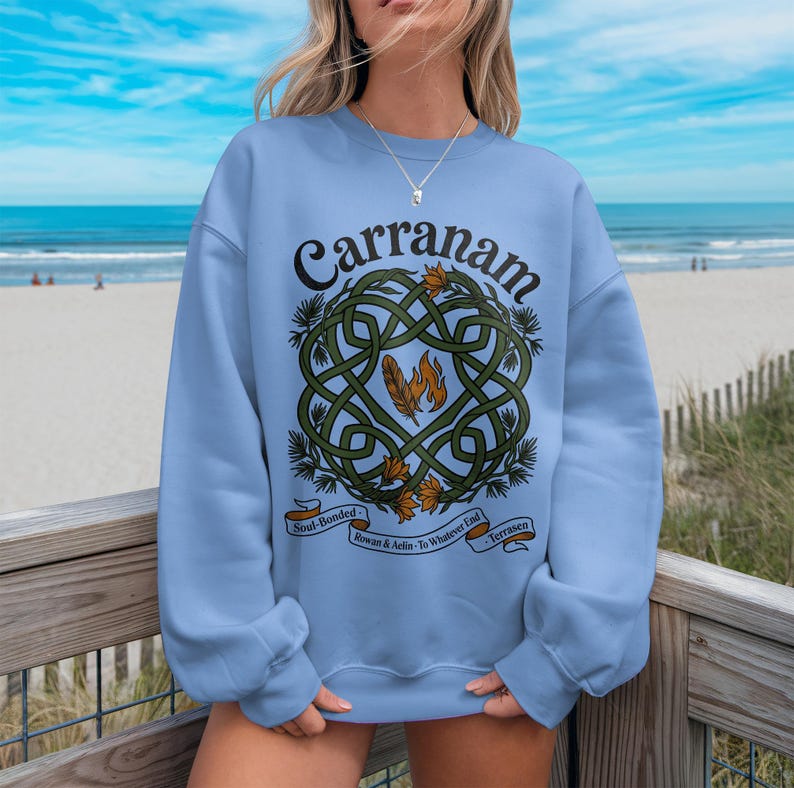 Light blue sweatshirt with green Celtic knot design and text "Carranam".