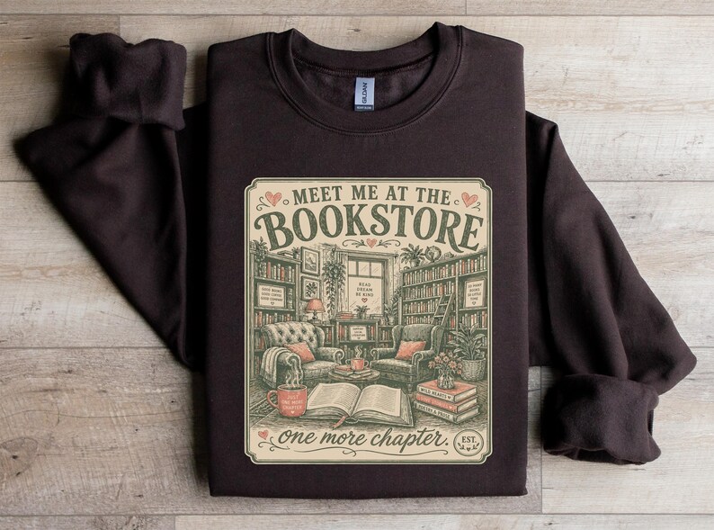 Dark brown sweatshirt with "Meet Me at the Bookstore" graphic.