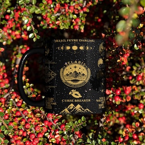 a black coffee mug sitting on top of a bush