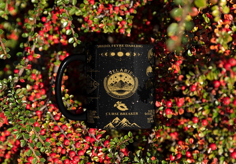 a black coffee mug sitting on top of a bush
