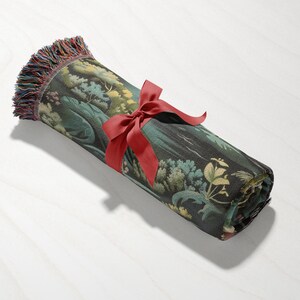 a rolled up piece of fabric with a red ribbon