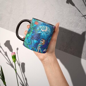 a person holding a coffee mug in their hand