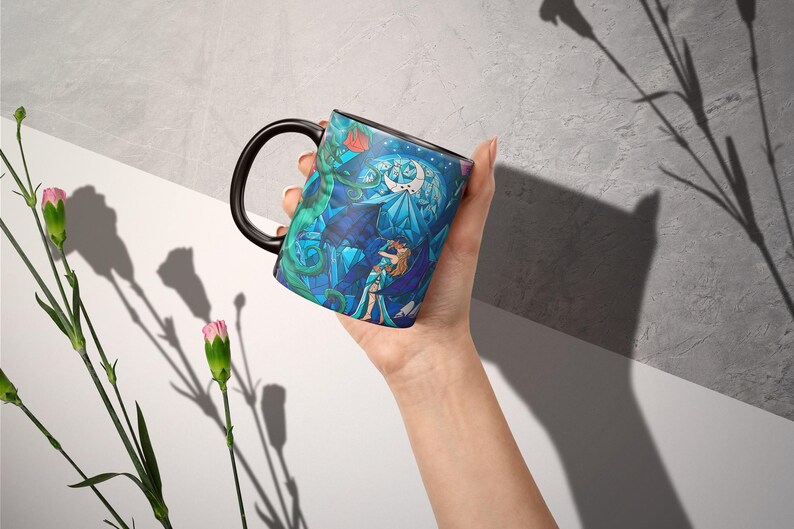 a person holding a coffee mug in their hand