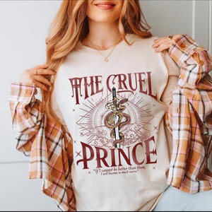 a woman wearing a t - shirt that says the cruel prince