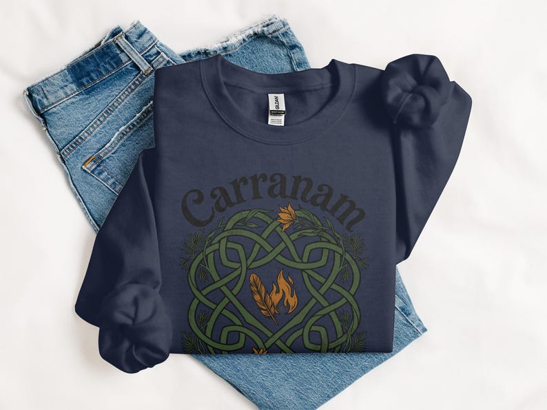 Navy sweatshirt with Celtic knot design featuring feathers and flames.