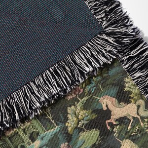a close up of a blanket with horses on it