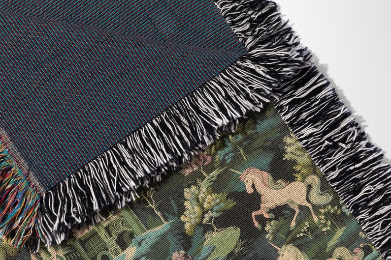 a close up of a blanket with horses on it